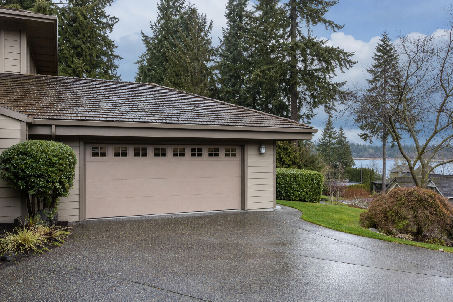 Mercer Island home exterior with a visible garage door on a damp day